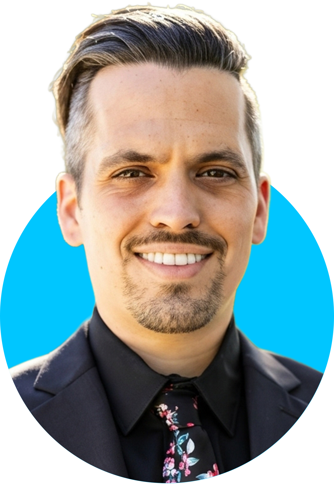 Brandon Guthrie, Chief Executive Officer (CEO) of Dream Design Labs, smiling in a suit with floral tie against a bright blue background.